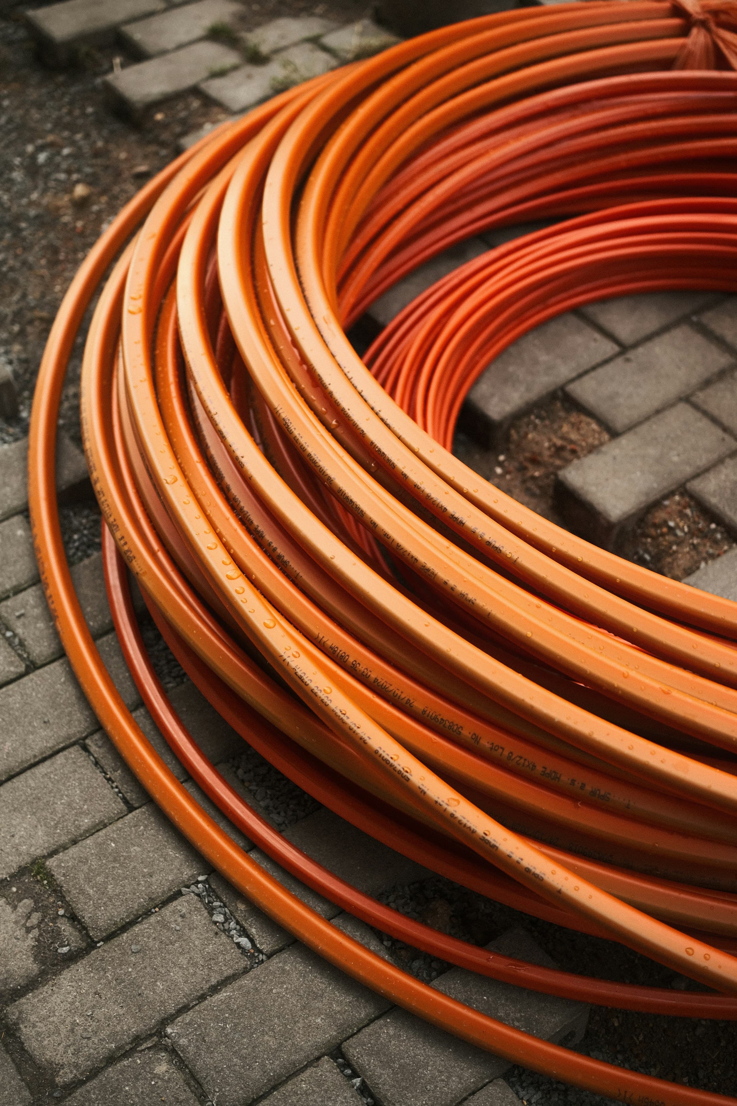 Coils of orange PEX tubing