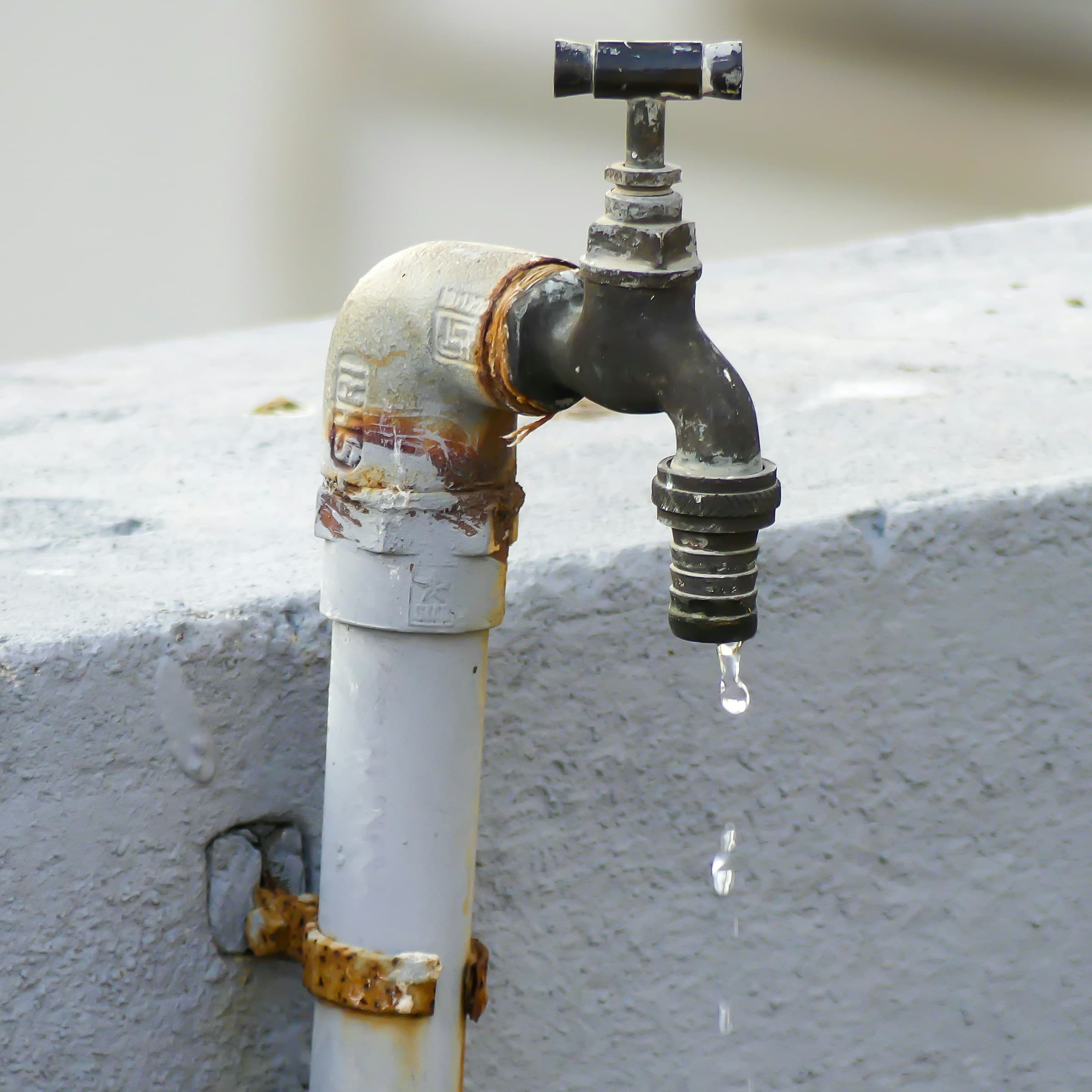 Corroded outdoor faucet dripping water