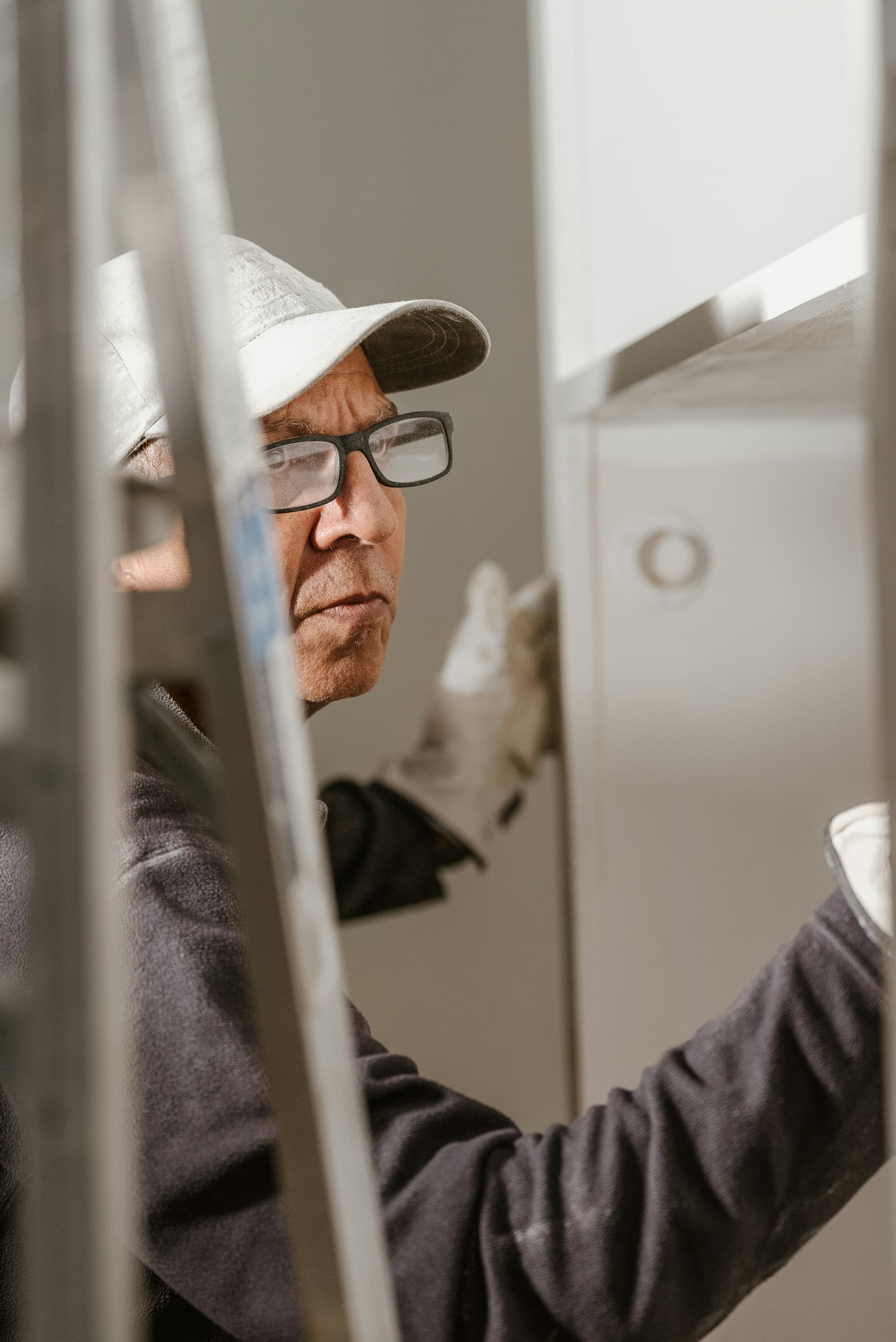 Plumber with glasses examining a fixture