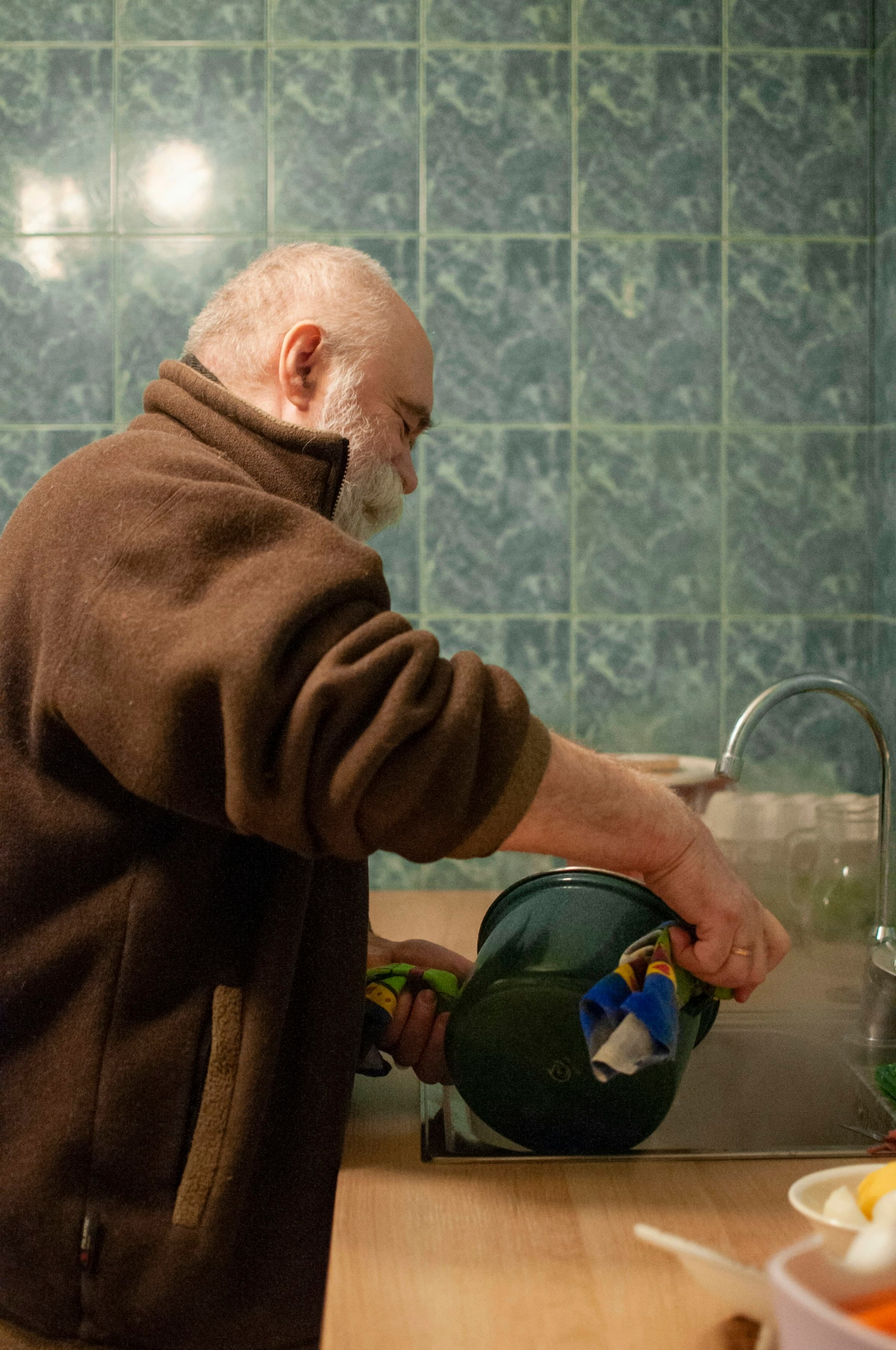 Plumber working on tiled bathroom plumbing